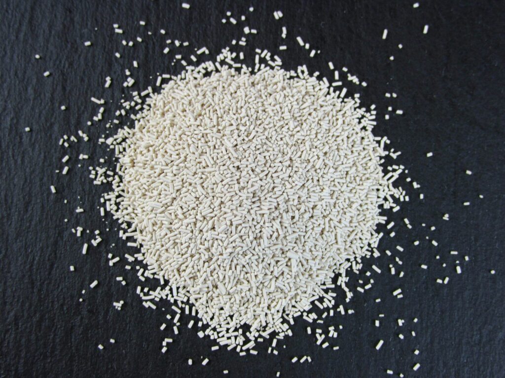 a pile of white rice sitting on top of a black surface